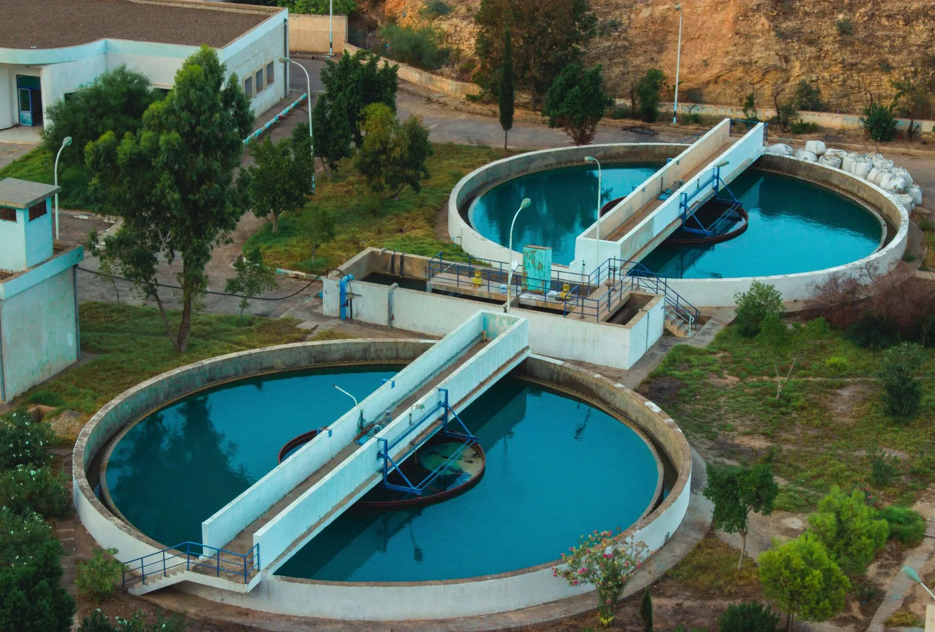 Aerial view of a water purification plant surrounded by trees